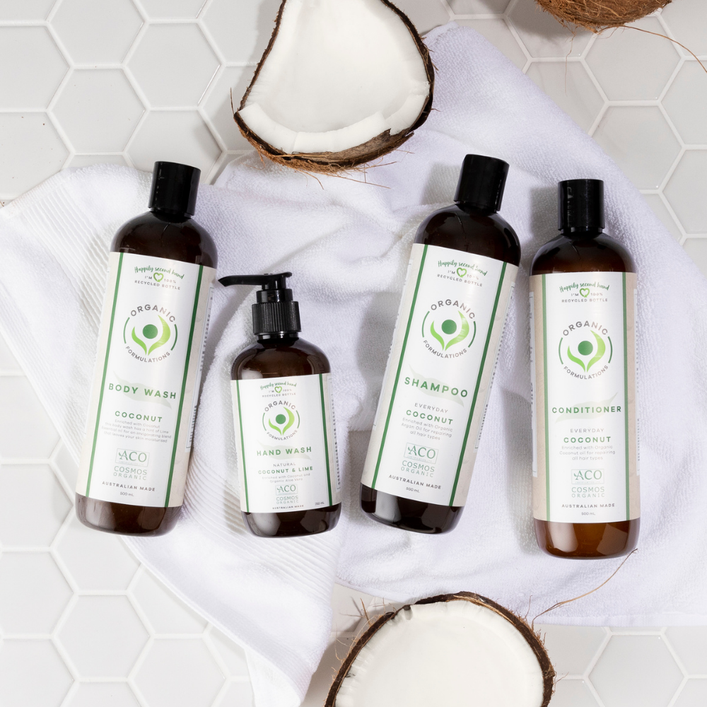 Organic Formulations Coconut Conditioner bottle styled with coconut halves